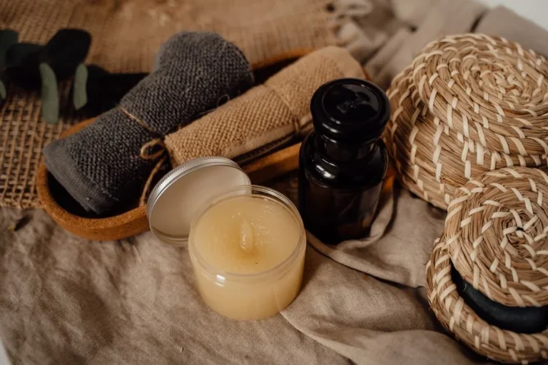 Aceite de masaje, vela y toalla sobre una superficie de madera
